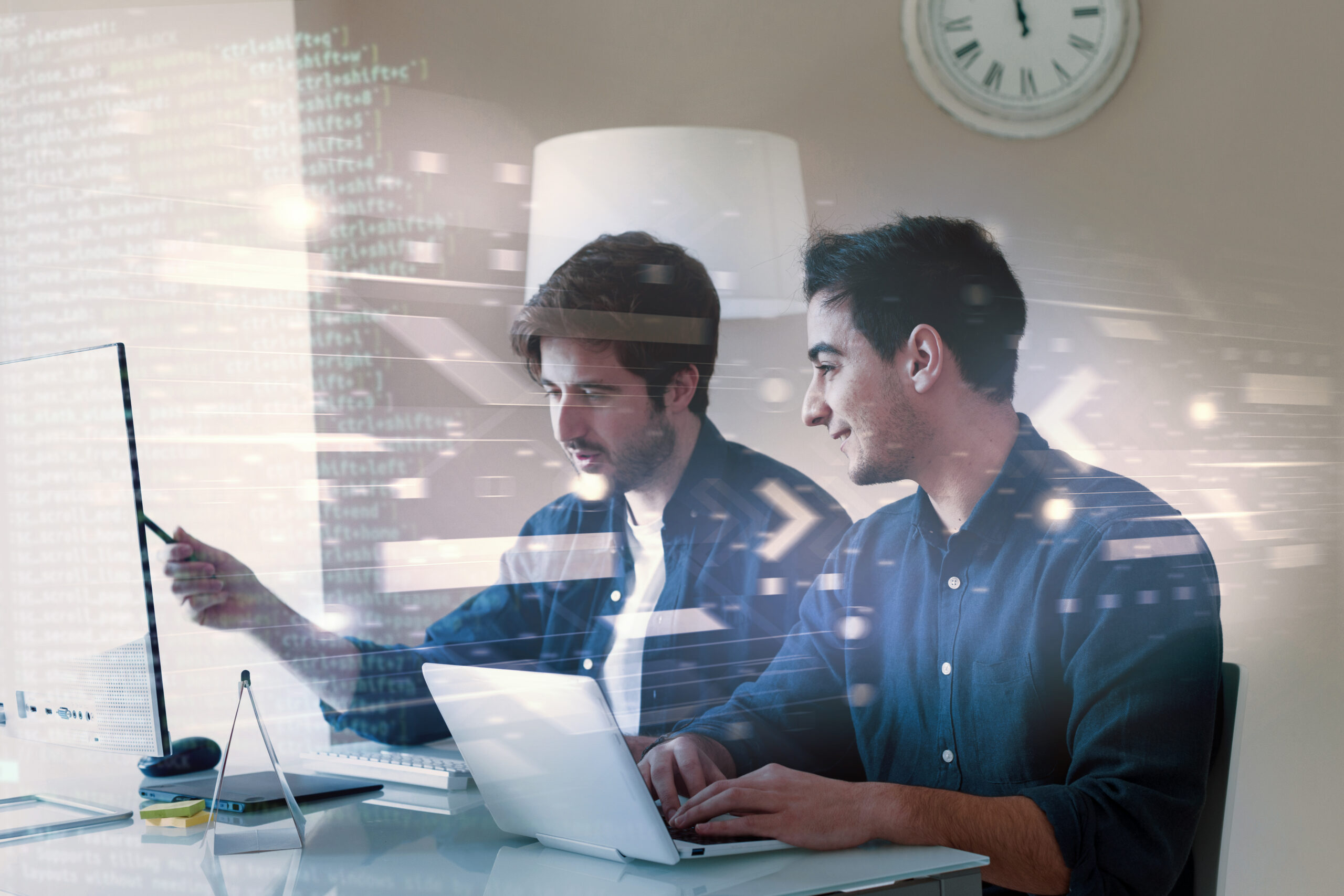 Two developers collaborating on frontend and backend code with a digital overlay of programming elements