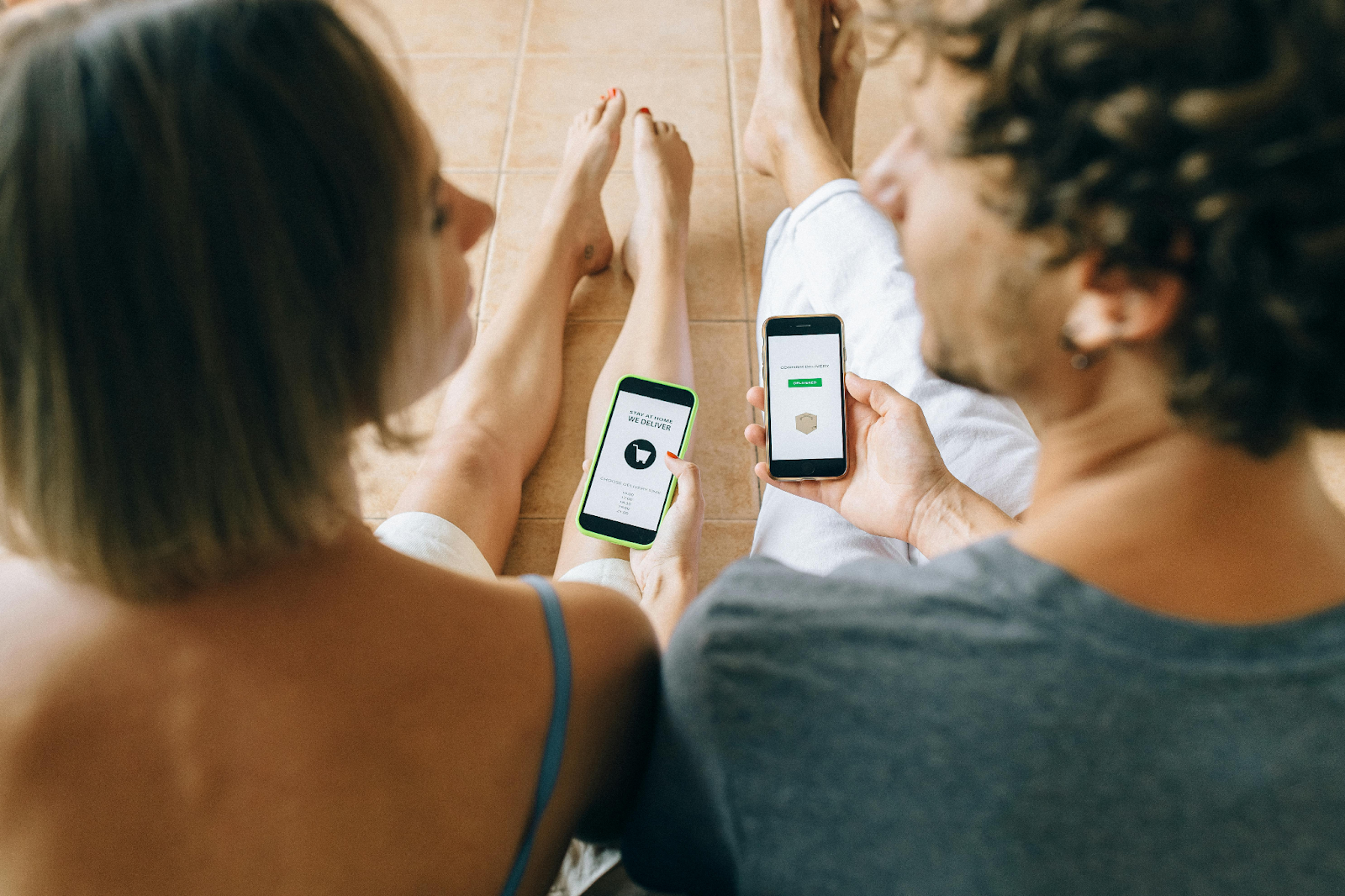 Two people using smartphones to track eCommerce orders