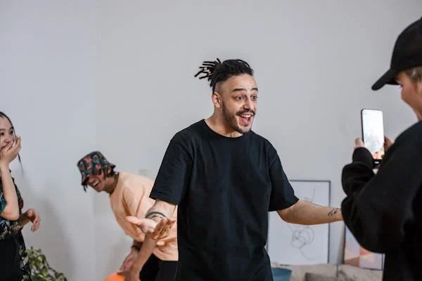 A content creator reacts while being filmed